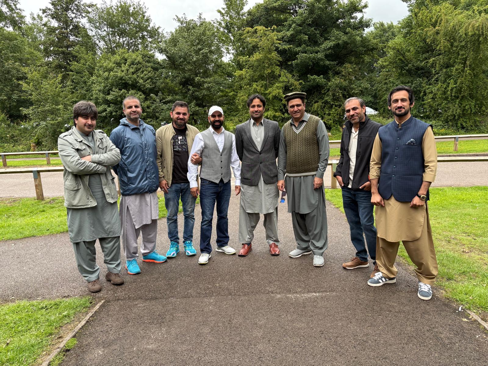 Eight of the walkers standing shoulder to shoulder on the path for a group photograph at the end of the walk